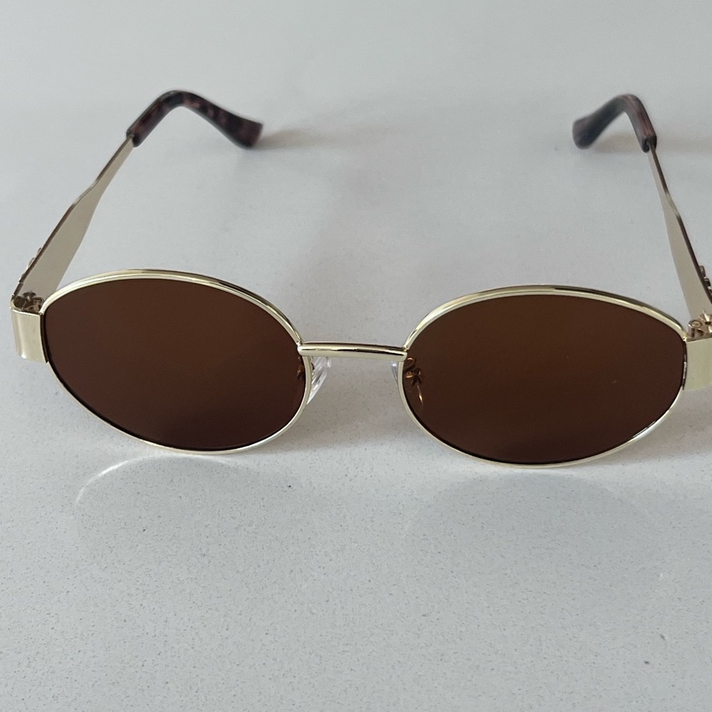 Chic Black and Gold Oval Sunglasses with Metal Frames - Picture 6 of 9